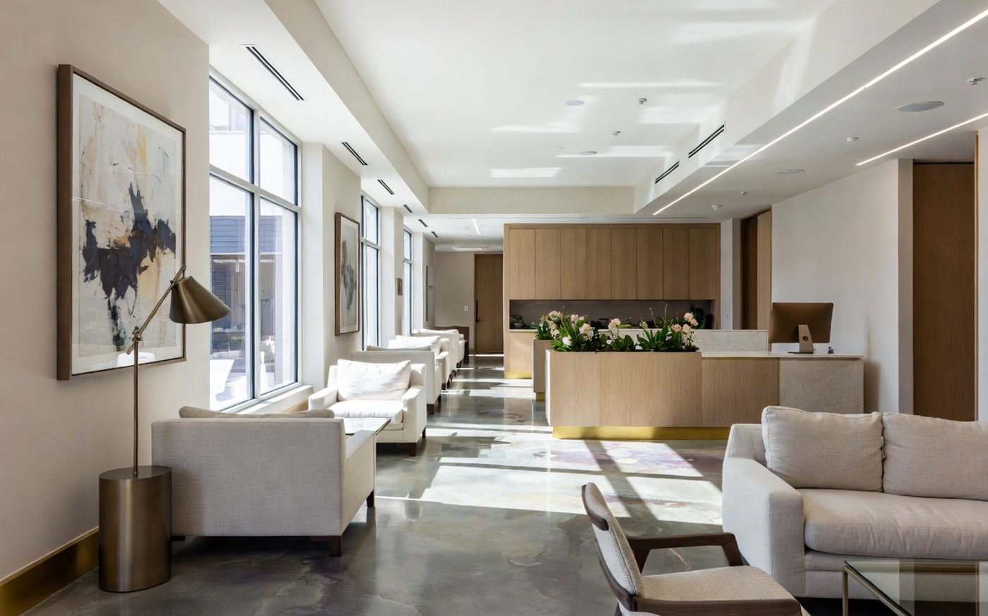 Elegant minimalist reception lounge at Apex Wellness with natural light and premium finishes